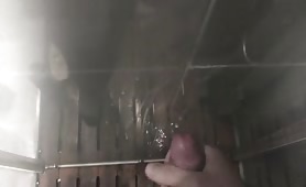 Massive cumshot on a shower glass wall