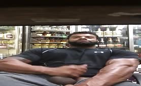 Big strong bodybuilder stroking his cock in a liquor store