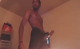 Horny black stroking his long oiled cock
