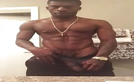 Hot muscular black doing a solo in front of the webcam